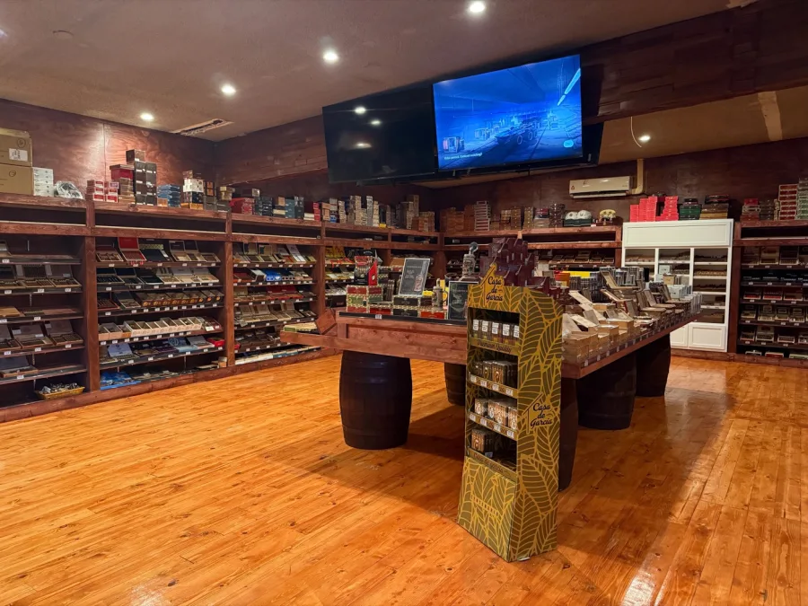 The walk-in humidor retail floor at Lord Puffer, lined wall to wall with cigar boxes on wood shelving